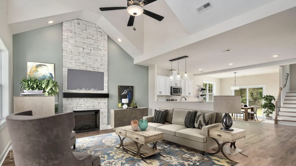 Interior living area with a floor to ceiling fireplace with white silver stone veneer