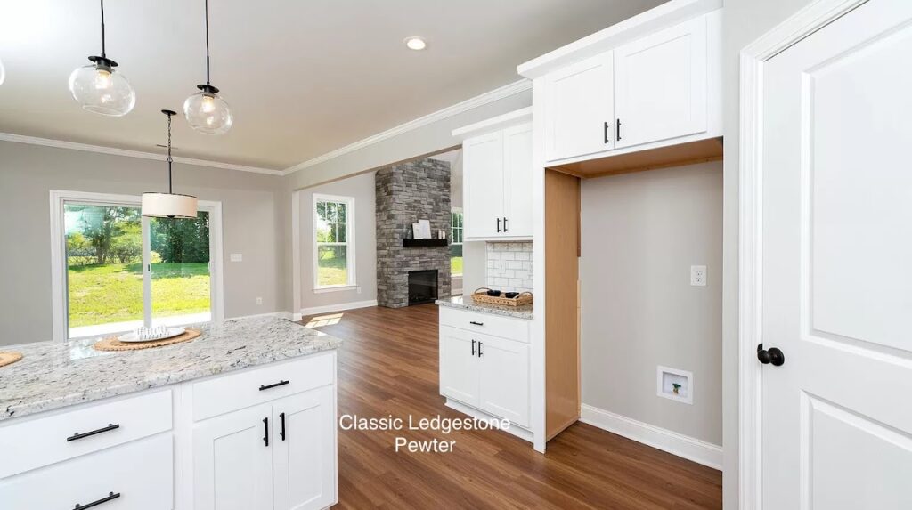 Cultured stone fireplace flanked with large windows, wood floors and sliding doors open to the outside patio help create a biophilic design.